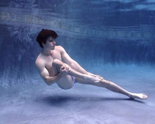 Underwater barefaced model in bulging underwear