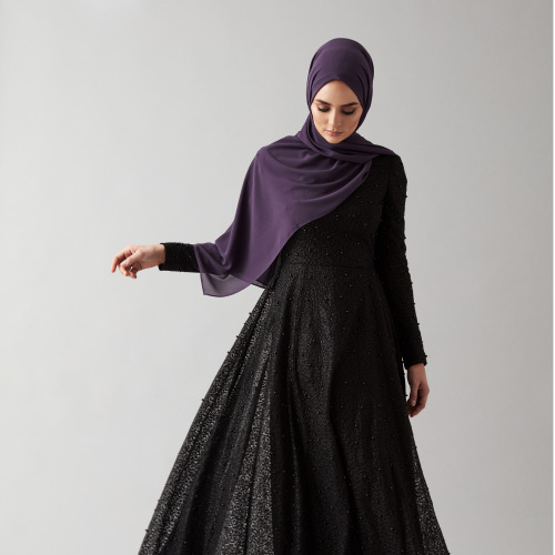 An embellished gown scattered with black pearls. The perfect evening wear dress due to its full embr