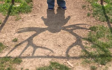 The Winged Boy  Shadow wings erupt from his ears, no, from  his neck. The branches arc skyward and his arms dangle like leaves. When he whirls, hemlines fling  towards heaven; eyeballs are skewered like marshmallows and drip down to his blue shoes...