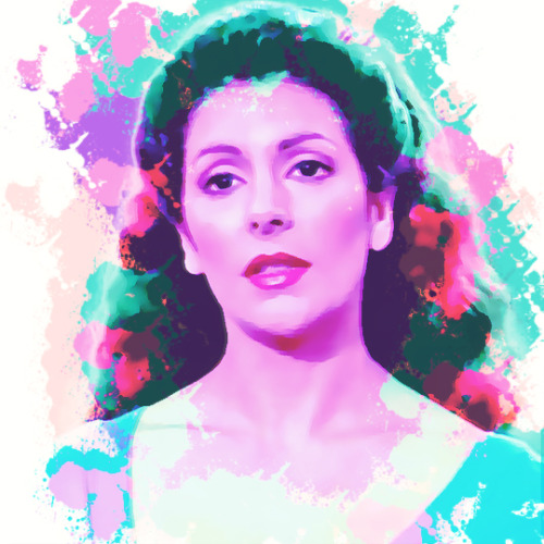 head and shoulders portrait of Deanna Troi with splashes of purple, pink and blue paint.