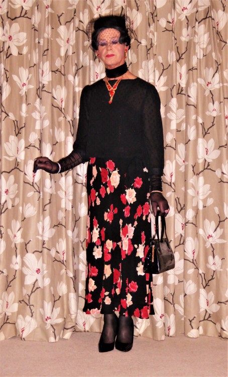 Chiffon sleeved blouse, floral skirt a veiled hat and handbags,