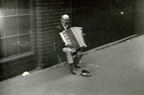 This photo of a dapper busker fell out of a secondhand book. All I know about it is what’s wri