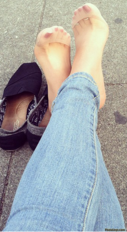 Pretty feet in jeans and pantyhose. And well worn flats.