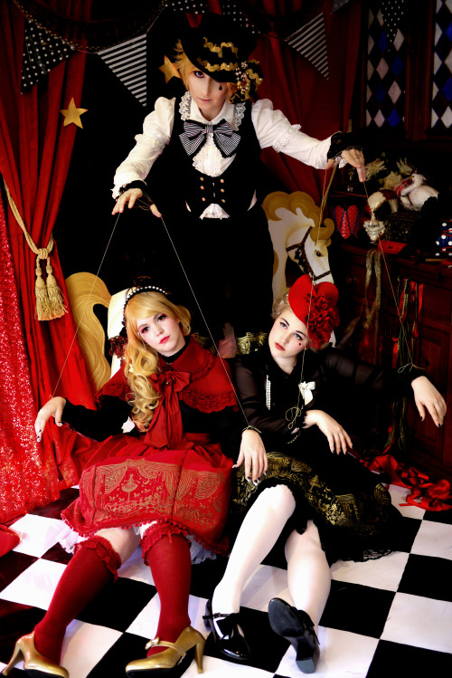 wisteria-bridge:  ‘Puppet Circus’ fashion shoot.The models are myself (black dress, red hat), Jemima (red dress), and Zimiel (black  suit). Photography by Karen. The set including horse prop and flooring was made by me, a labour of love haha, we