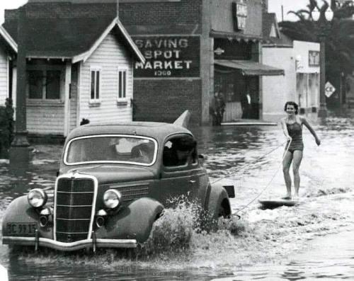 blondebrainpower:Mary Anne Hawkins surfing the flooded streets of Long Beach, California. 1940s