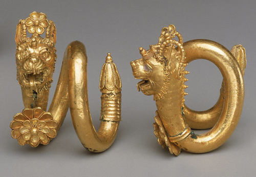 ancientpeoples:Gold and copper alloy spiral earrings with lion-griffin head terminalGreek or Cypriot