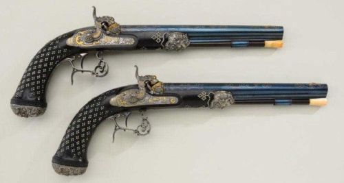 An ornately engraved gold and silver decorated set of dueling pistols crafted by Andreas Kuchenreute