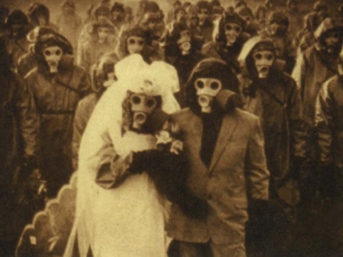 sixpenceee:  Wedding picture in Izu Island in Japan. The habitants used gas masks because there were high levels of sulfur in the air due to volcanic activity.   Wellcome to the Black Parade.
