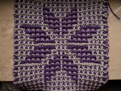 A thing I made with yarn I got from @curufins-smile. My first time trying mosaic knitting and it was