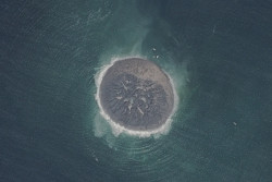 untrustyou:  This satellite image shows a small, new island made of rocks and mud that emerged off the coast of Gwadar, Pakistan, after a deadly earthquake struck western Pakistan (9/24/13).  CNES/Distribution Astrium Services/Agence France-Presse 