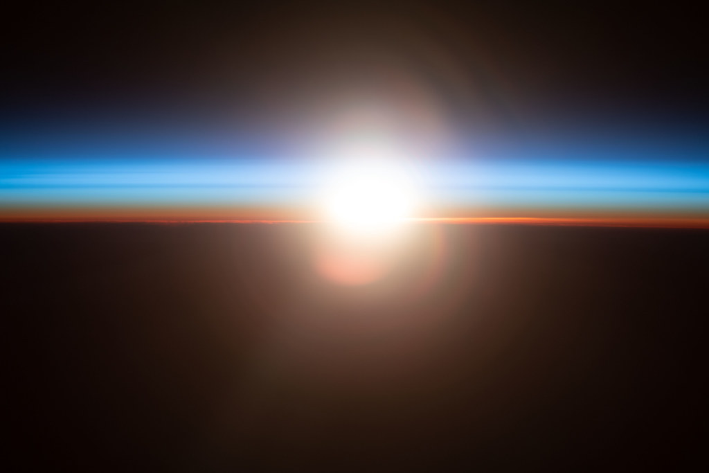 An orbital sunrise above the Pacific Ocean by NASA Johnson