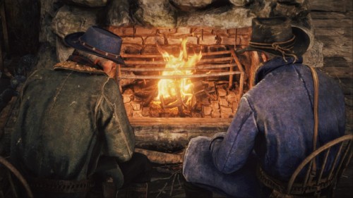 Arthur and Hosea sit by the fire