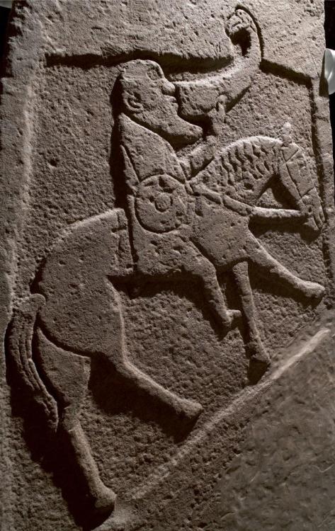 celtic-studies:Pictish sculptured stone slab depicting a horseman with sword and shield drinking fro
