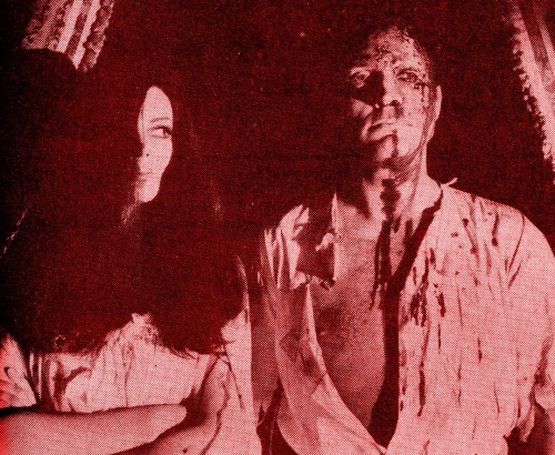 Barbara Steele eyes her bloodied lover, Rik Battaglia, after he is tortured in Nightmare Castle