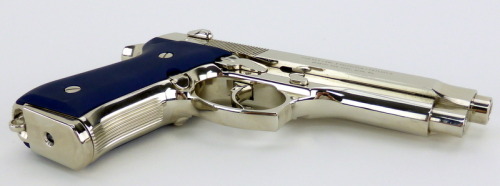 fmj556x45:  Beretta 92F 9mm Para caliber pistol. Customized Italian gun with bright nickel finish and blue Aluma grips.