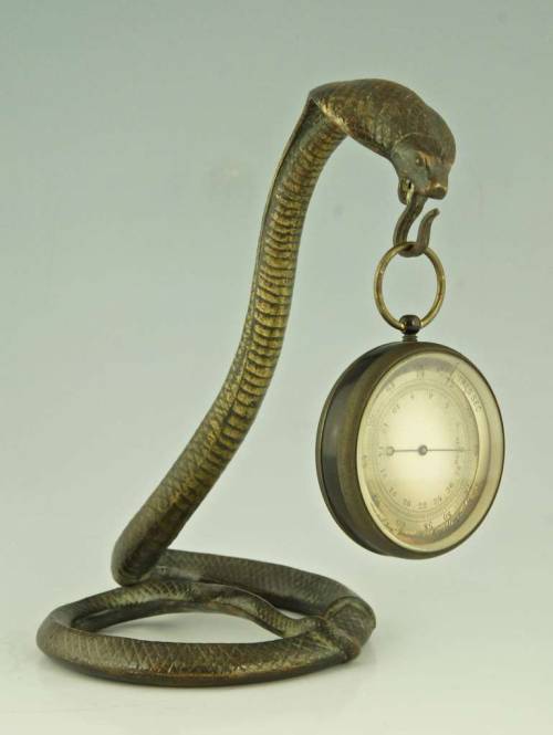 typhonatemybaby:madamecuratrix:From source:A bronze cobra snake pocket watch stand by  Edgar Brandt.