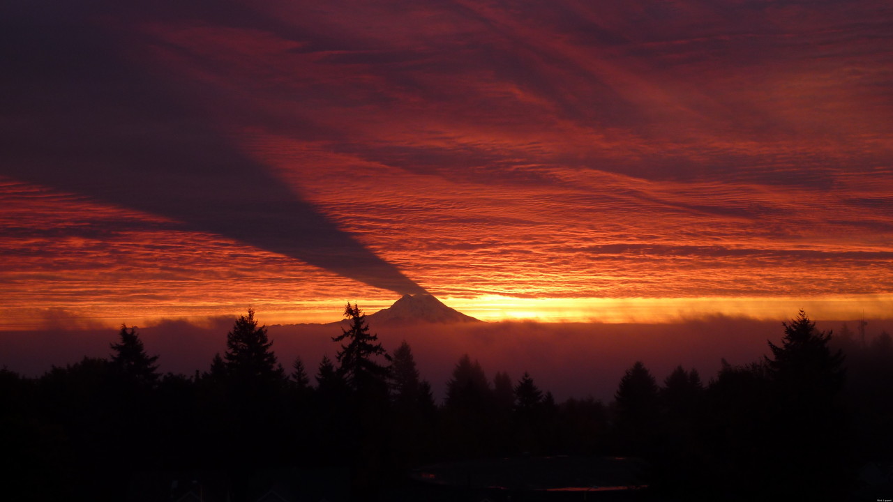 Mount Rainier shadow casts on the sky at sunrise. It only happens when the sun rises