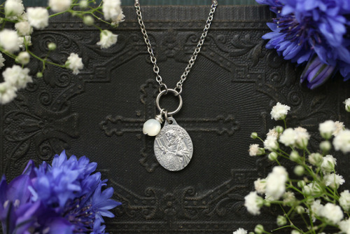 Antique white rosary mother of pearl beads and vintage pilgrim medals made into elegant necklaces.Av