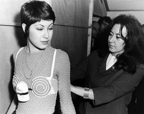 historylover1230: A model is seen trying on a spiral electric bra at the “20th International S