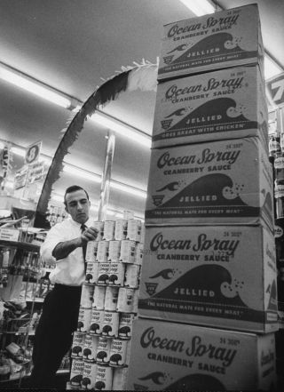 A worker stacks cranberries during America’s first food scare, in 1959.