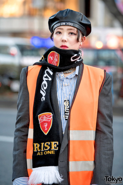 17-year-old Japanese student Lisa on the street in Harajuku wearing a vintage orange safety vest ove