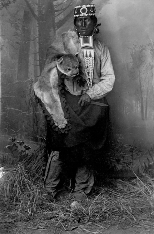 thebigkelu:Jicarilla Apache Man in Partial Native Dress with Knife and Feline Animal Costume - Randa