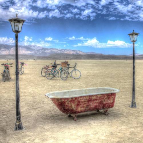 A tempting red clawfoot bath tub, between street lights on the playa, jump in and take a dust bath! 