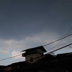 Silhouette of a house against the cloudy