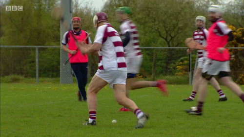 Adrian Chiles playing a game of hurling in “Christine & Adrian’s Friendship Test” s1e02