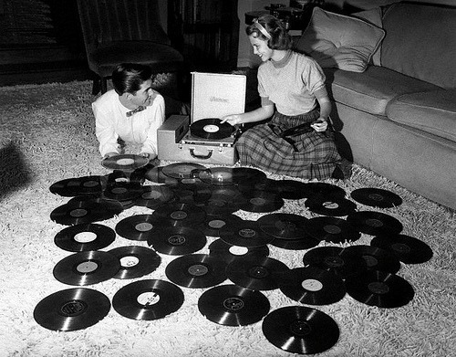 woodstockbaby1969:
“ Young couple playing records spread out on living room floor.
Ohio, 1955.
”