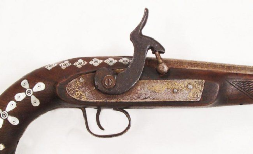 An Afghan decorated percussion pistol with pearl and gold inlays, late 19th century.