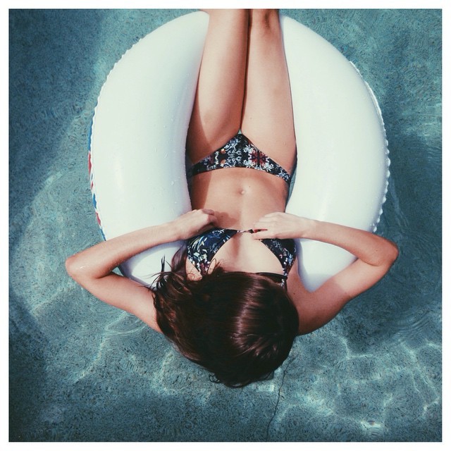 Lazy pool days ☼ wearing our midnight tropic triangle top and cheeky bottoms |