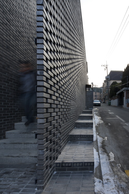 dezeen:  Perforated brick walls front this Seoul office block by Wise Architecture, flanking staircases that lead up to a rooftop terrace with views of a nearby historic park »