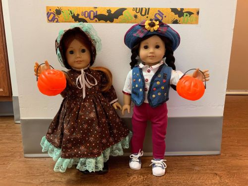 A Very Merry American Girl Halloween. Some of the dolls are wearing the same costumes from last year