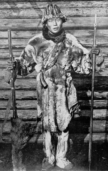 An Orochon hunter poses with his musket and spear, Eastern Siberia, 1939.