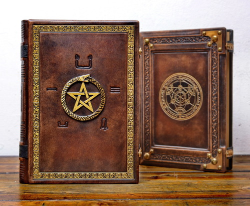 Two large and heavy leather books with alchemical symbols… 10"x14", 500 pages, hand