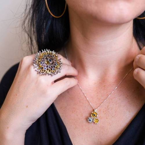 Enclosed radial ring, with it’s a halo of Australian blue sapphires, and an emerging pendant. 