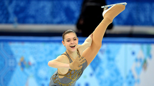 Adelina Sotnikova. Architectural gold blinging against a soft grey backdrop. One handed Beilmans. 