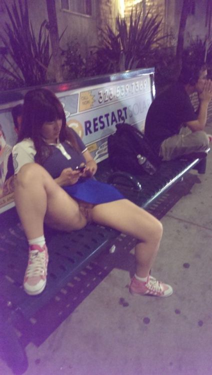 carelessinpublic:  In a short skirt in a bus stand and showing her pussy