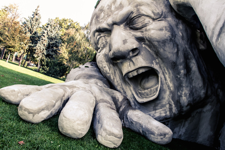 mymodernmet:  A gigantic man crawls out from the earth in this spectacular outdoor