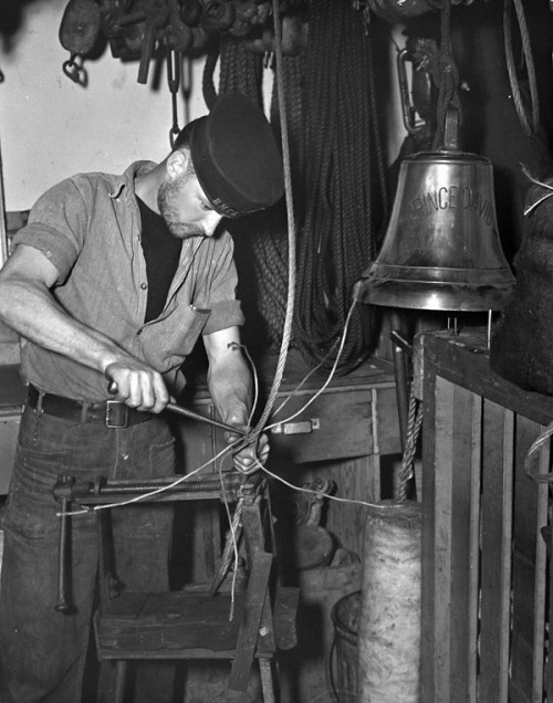 Able Seaman Murray Kennedy splicing cable aboard H.M.C.S. PRINCE DAVID, Cowes, England, 10 May 1944.