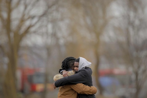 People who fled the conflict from neighbouring Ukraine embrace after crossing the border at Siret in