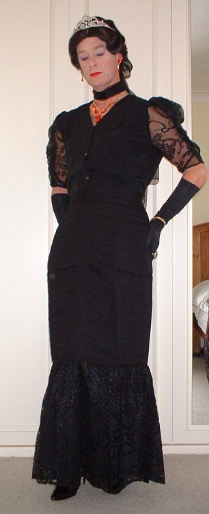 Long flounced evening skirt with chiffon sleeved blouse, chiffon scarves and wrap, patent black clut