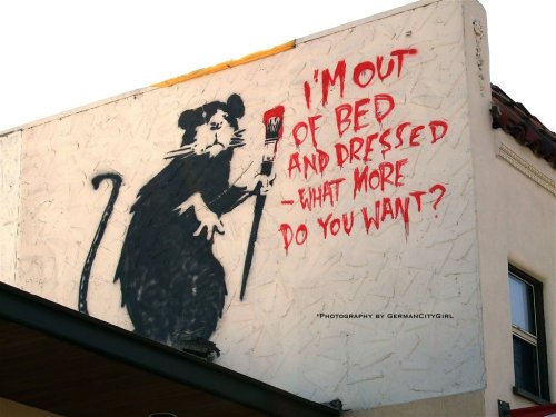 optates:  Banksy, a street artist whose identity remains unknown, known for his provocative stenciled pieces in the late 1990s.  