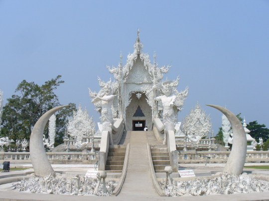 madeleineengland:  Wat Rong Khun, better known to foreigners as the White Temple, is a contemporary, unconventional, privately-owned art exhibit in the style of a Buddhist temple in Chiang Rai, Thailand. Chalermchai Kositpipat constructed it and