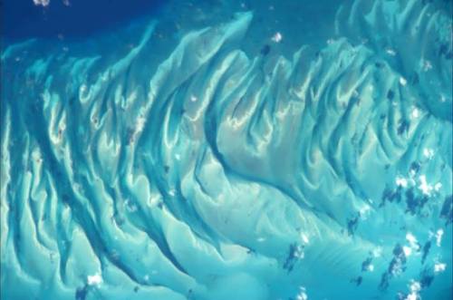 Underwater folds These sand formations were snapped from space under the crystal clear waters of the