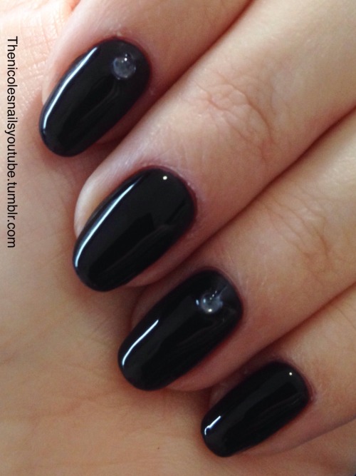 Black high shine nails with studs.