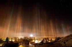 sixpenceee:  Light PolesThis phenomenon is known as ‘light poles’ and it can be seen at nights  over the large cities with different colored lights. They can only be  seen during very cold weather (the temperature of -20 Celsius degrees or  lower