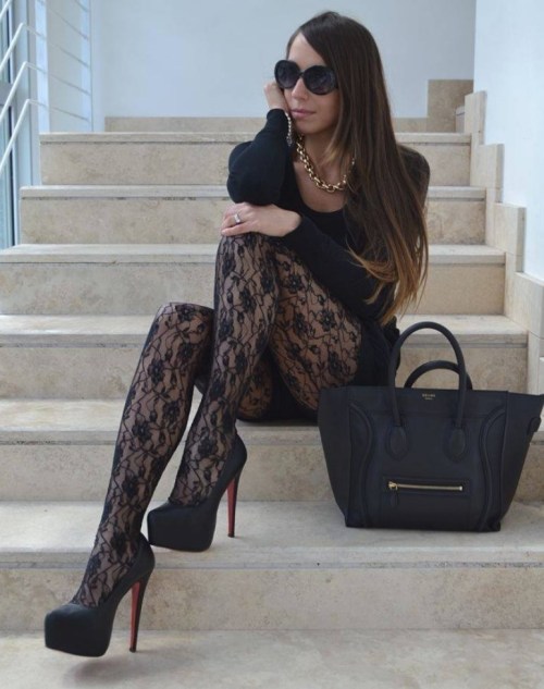 Black lace tights with compensated heels and body conscious dress