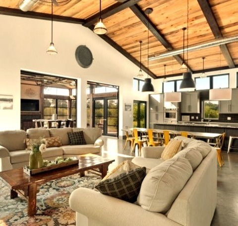 Open - Living RoomLarge Industrial Open Concept Living Room With A Brown Floor, A Concrete Floor, And